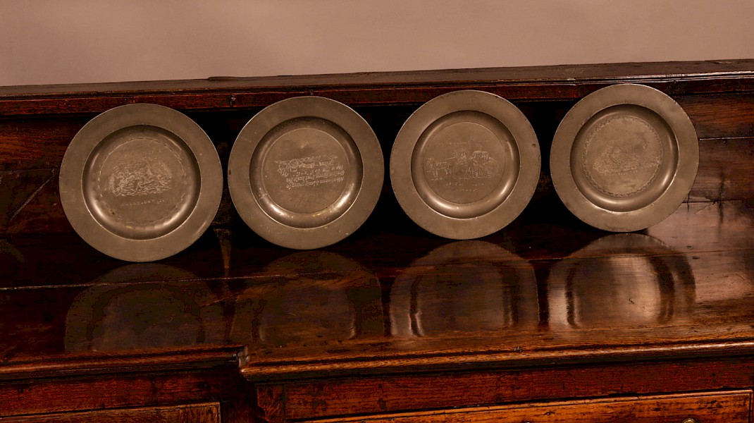 A Set of 4 pewter plates with engraved decoration