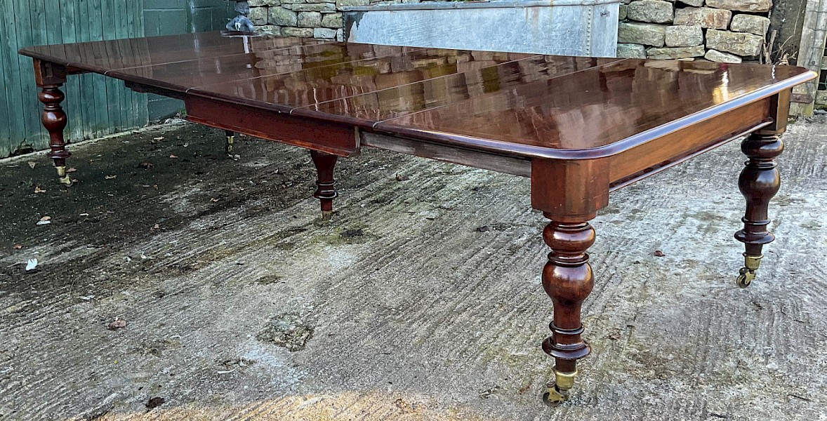 A Rare Early Victorian Extending Dining Table with inlay to the top seats 14