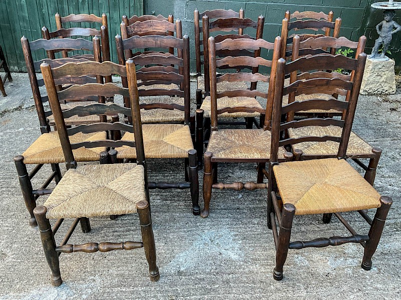 a harlequin set of 12 early 19th century ladder back chairs