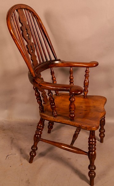 A Good broad Arm Windsor Chair in Yew with an Elm Seat