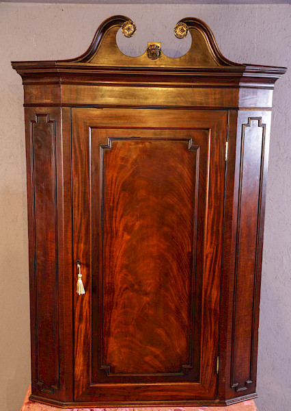 A Super Georgian Corner Cupboard with broken arch pediment